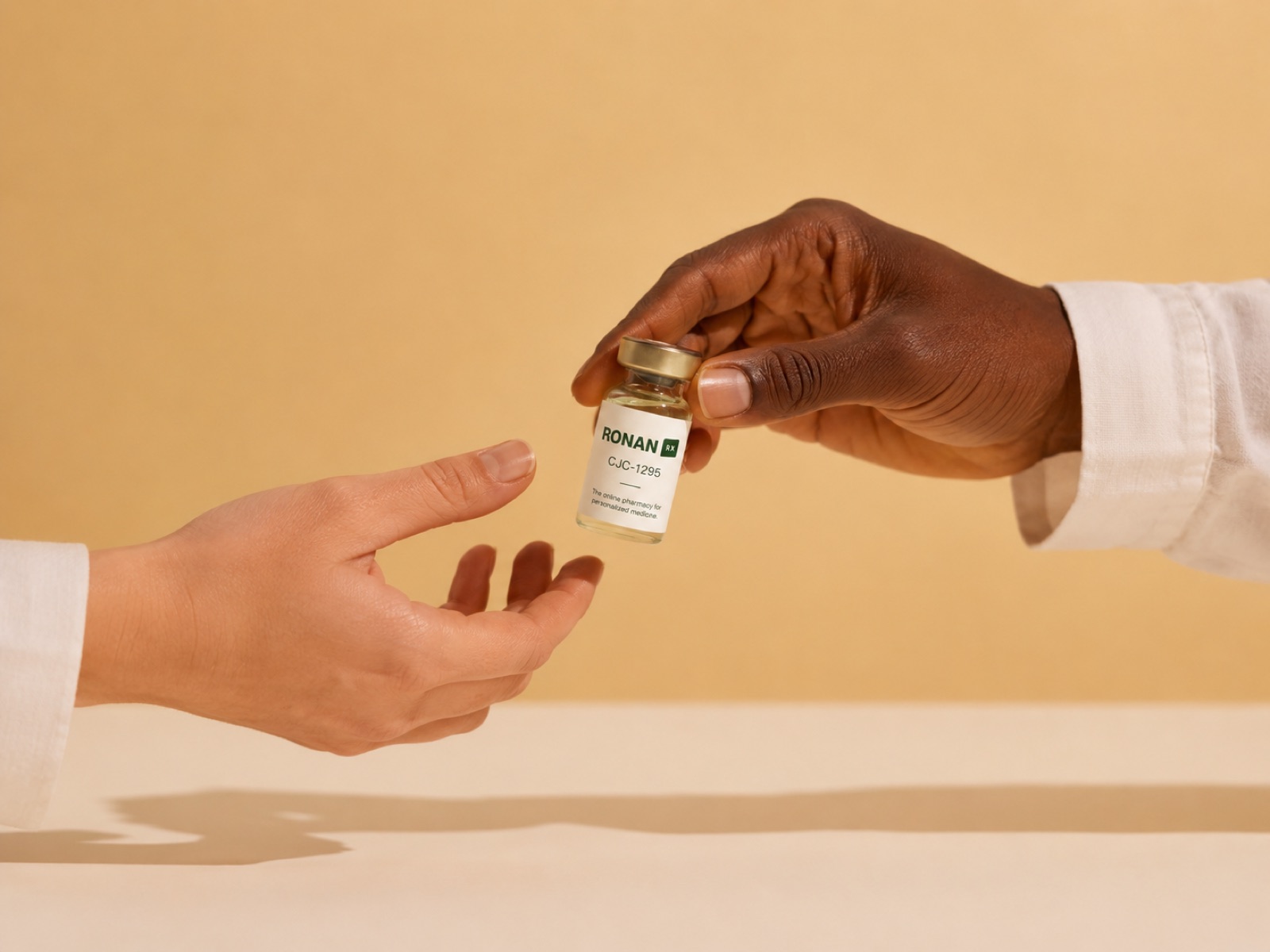 A clinician hands a labeled prescription vial to a patient.