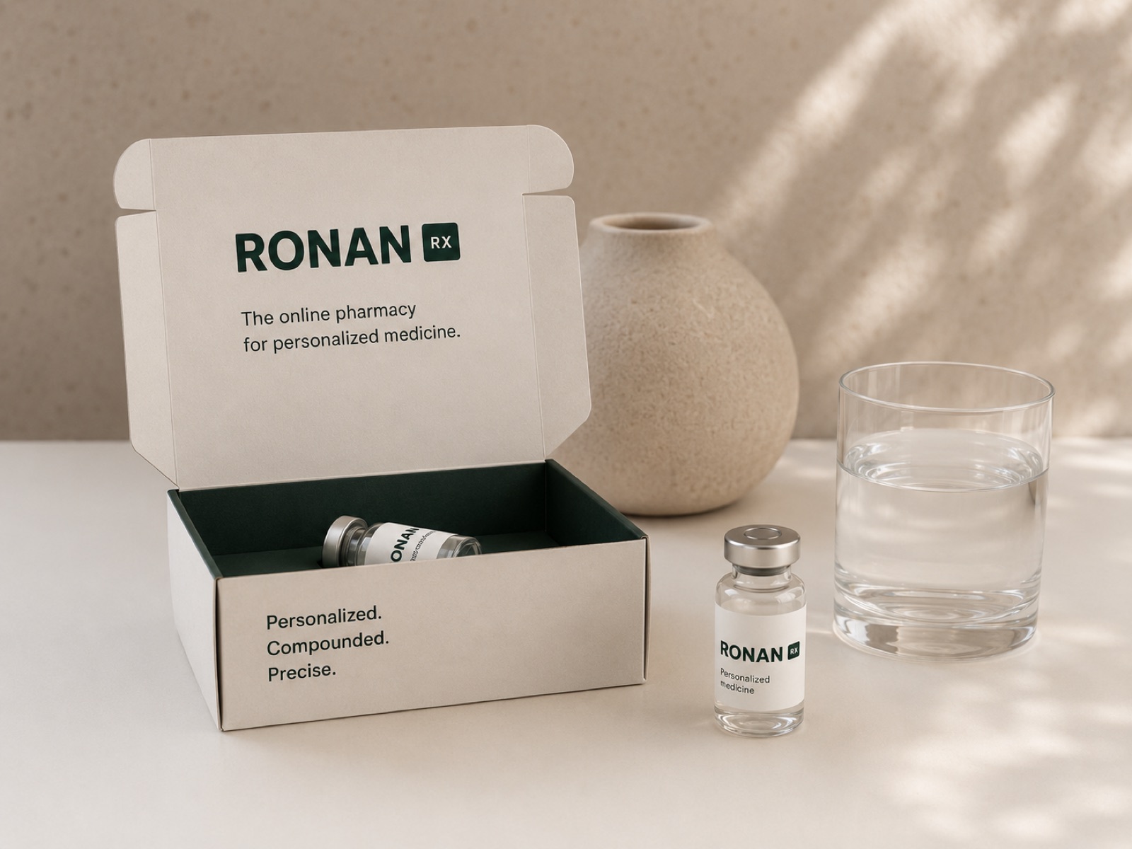 A personalized RonanRx medicine box opened beside a glass of water.